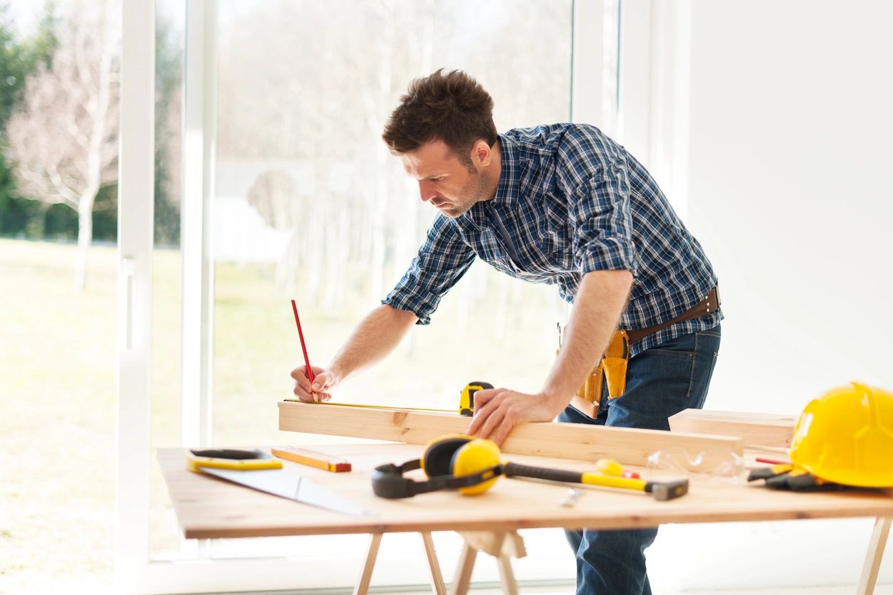 A man working on a table with tools in front of him.